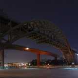 Going past the two �rsta bridges and looking at them from the south-east side one gets a view toward Hornstull under the span. The rightmost bridge is the old �rsta bridge, and the scaffolding used for restoration and preservation efforts can be seen lit up at the far end of the bridge. It is currently used for commuter trains, while the long-distance trains are routed over the new bridge, whose slim shape stands in sharp contrast to the heavy framework of the old. The view from southbound commuter trains during sunrise is quite a sight. The train is high enough so that you see over the sides of the bridge, and since the train itself is on the east (trains go on the left-hand tracks) track, you see a beautiful sunrise over the water.