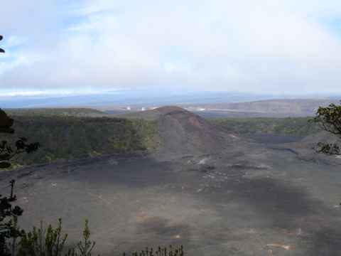 The Kilauea Iki crater, immediately to the east of the Kilauea caldera (which can be seen in the background). The Kilauea Iki crater, immediately to the east of the Kilauea caldera (which can be seen in the background).