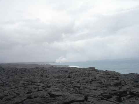 The current lava flow. The lava travels through channels in the rocks that open up underwater. The steam plumes indicate where the hot lava meets the seawater. This is where new land is being created. The current lava flow. The lava travels through channels in the rocks that open up underwater. The steam plumes indicate where the hot lava meets the seawater. This is where new land is being created.