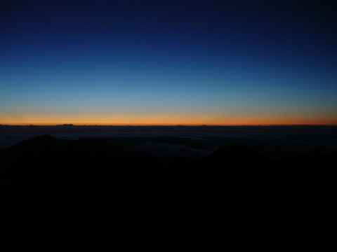 After forcing myself out of bed at 0300 we were taken to the top of Haleakala. At 0530, this is what the horizon looks like.