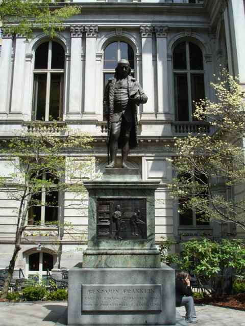 Benjamin Franklin. This is the first statue in the US that showed the person depicted in typical clothes. Other statues, such as the one of Quincy Adams just ten meters away, used the old heroic / roman style of clothing.