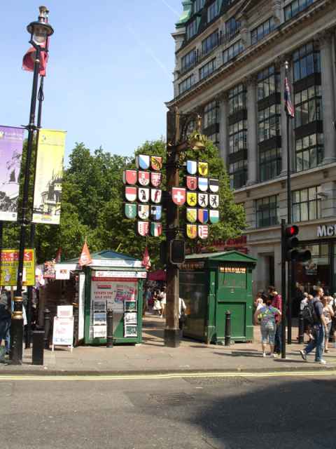 Gift from Switzerland in Leicester square. The canton where gustav lived before moving here has the shield with a horizontal blue bar on white background which is in the second column of the second row on the right hand side.