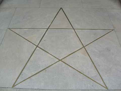 Pentagram on the floor immediately in front of the entrance. The top of the start points into the museum. Pentagram on the floor immediately in front of the entrance. The top of the start points into the museum.