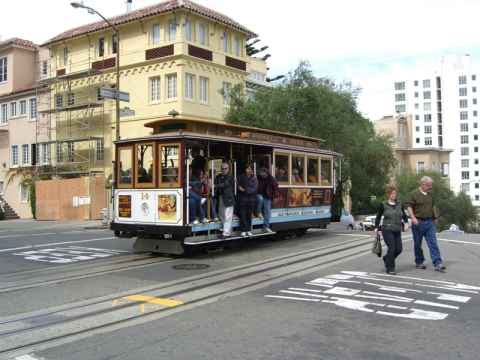A tram. The trams are driven by cables being pulled through the "middle rail" that you can see. The cables are continuously running and the car is driven by gripping the cable or by applying brakes. You can try driving a tram at Gripman's. A tram. The trams are driven by cables being pulled through the "middle rail" that you can see. The cables are continuously running and the car is driven by gripping the cable or by applying brakes. You can try driving a tram at Gripman's.