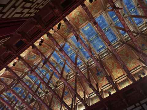 The council chamber ceiling. Originally the ceiling was intended to be flat, with the beams being hidden, but it was later decided to open it up and give the chamber a higher ceiling, which is 19 meters from the floor at the highest point. The beams are encased in a wood boxes.